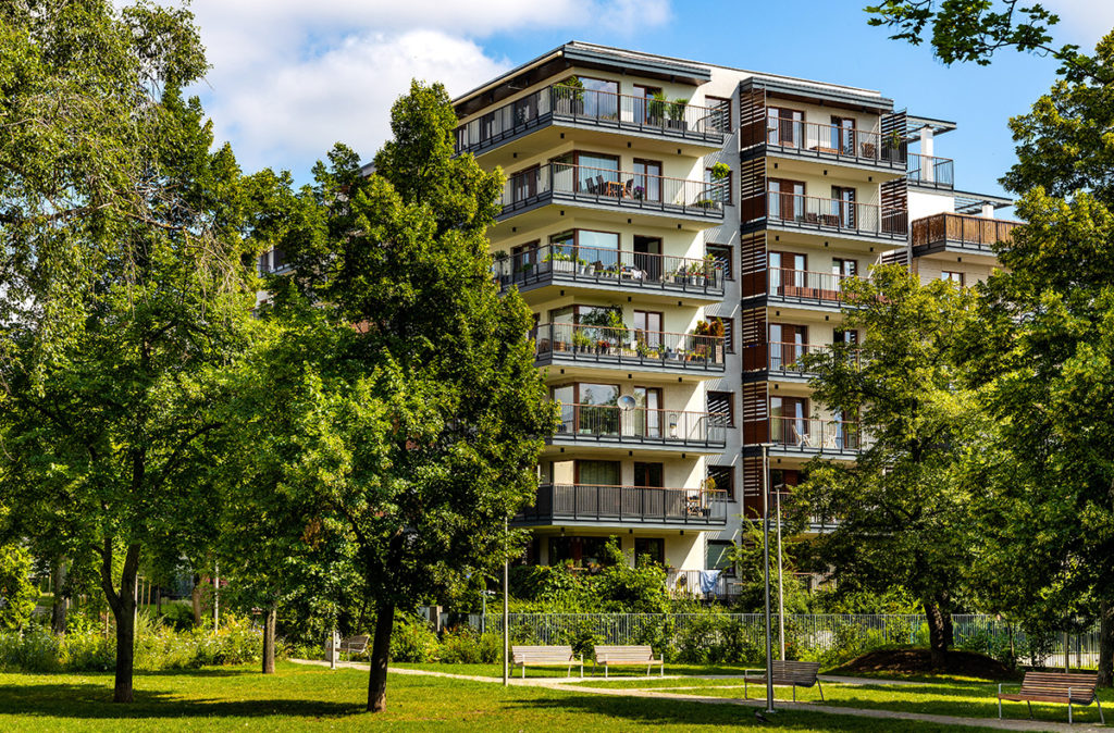 An apartment building surrounded by trees.